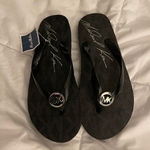 Michael Kors ladies size 9 black flip flops new with tags.